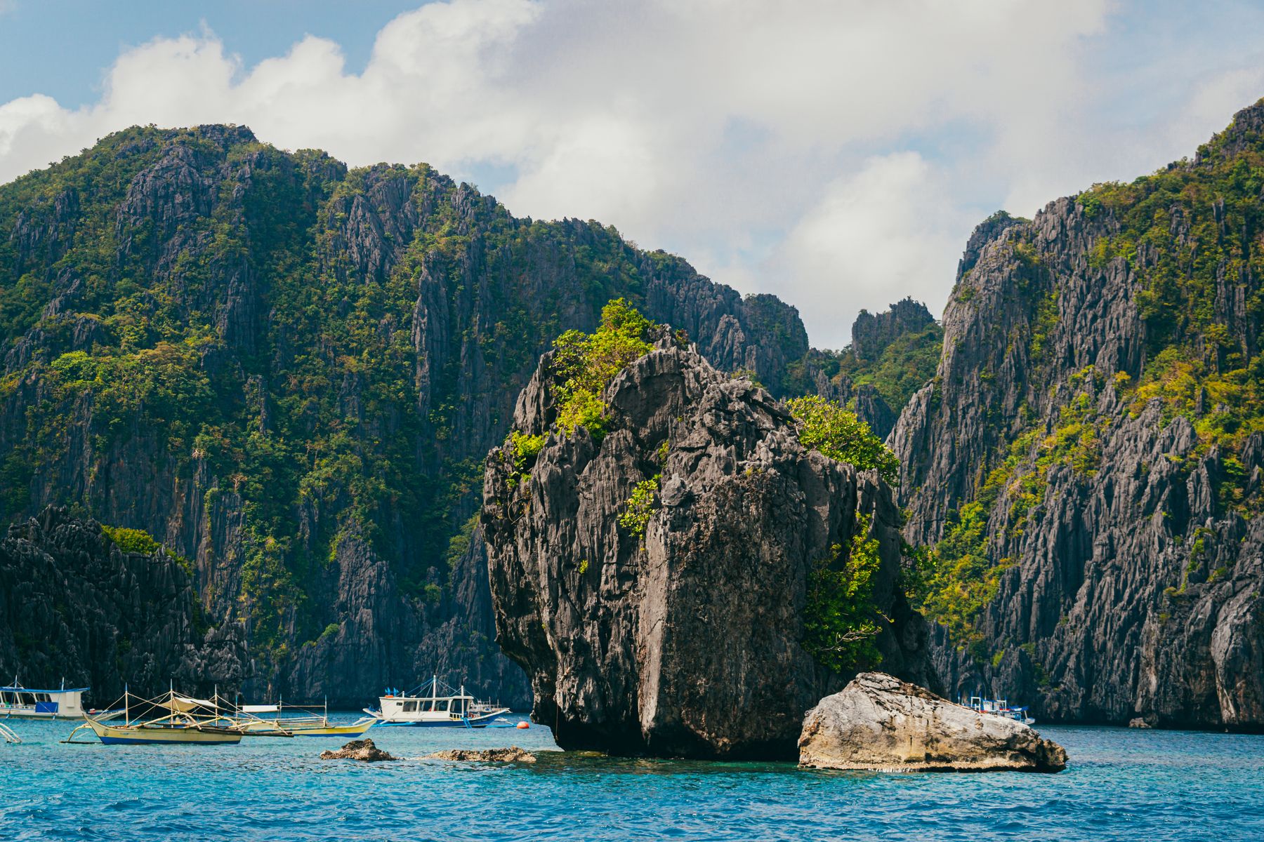Les bangkas au pied des karsts d'El Nido, dans un lagon turquoise à Palawan
